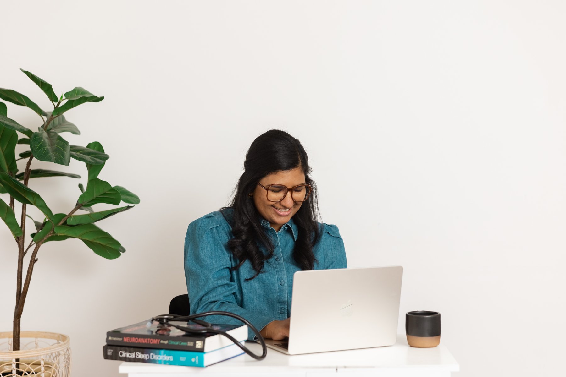 Dr. Divya Gupta working at her desk during a virtual visit
